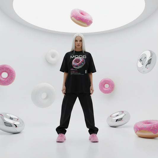 Blonde model wearing a black t-shirt with a donut graphic in a futuristic setting with floating donuts and circular structures.