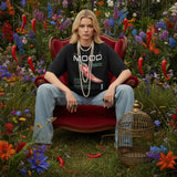 Woman sitting on a red chair in a garden with flowers and birds cages